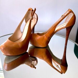 Guess tan platform pumps